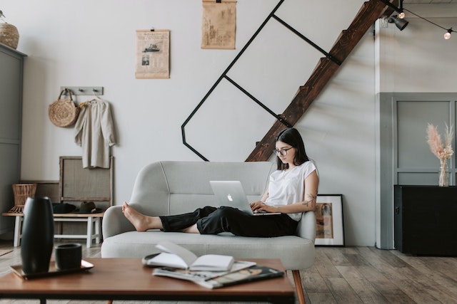 Strategi email marketing: Content young woman using laptop in modern living room