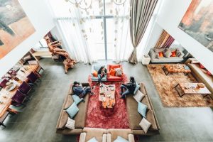 Desain apartemen minimalis: Aerial Photography of Three People Sitting on Sofa